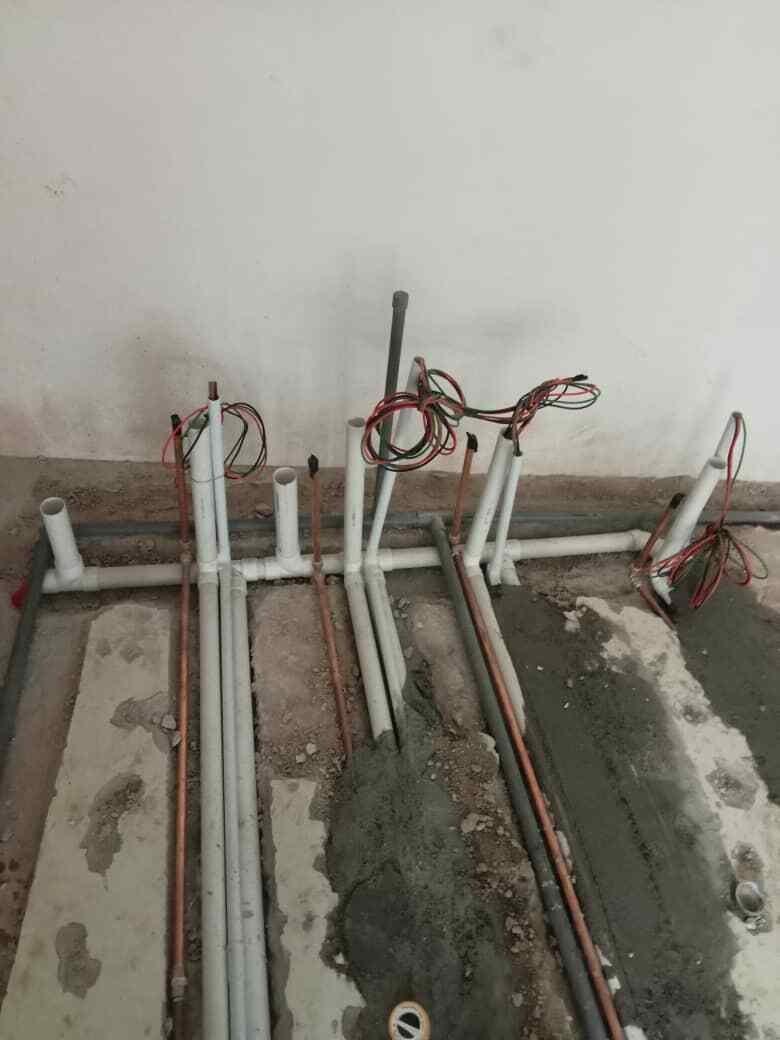 Plumbing pipes and electrical conduits installed during construction in Malaysia